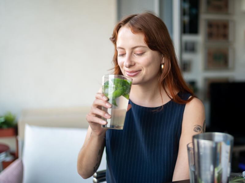 woman smiling with mojito cocktail