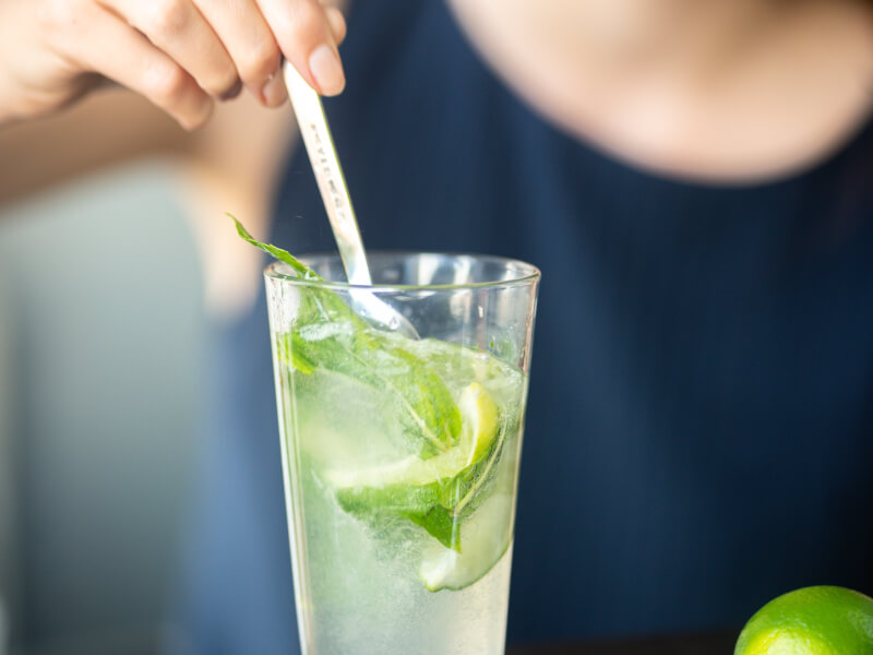 stirring a mojito cocktail