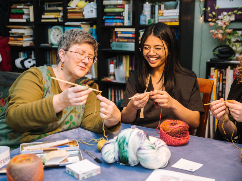Narda at crochet class with student