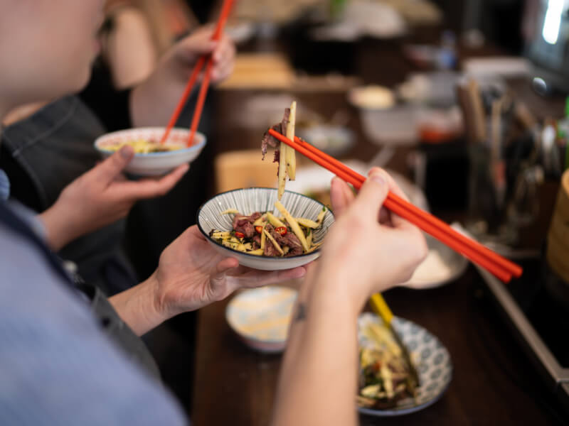 eating asian salad with chopsticks