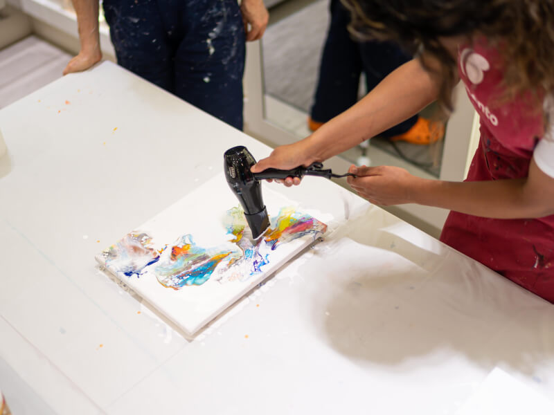 Using a blowdryer to move paint on a canvas
