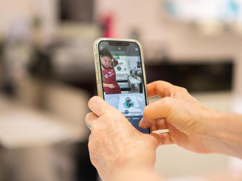 Close-up of person taking a picture with their phone
