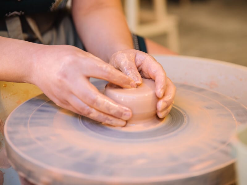 Close-up of woman wheel throwing