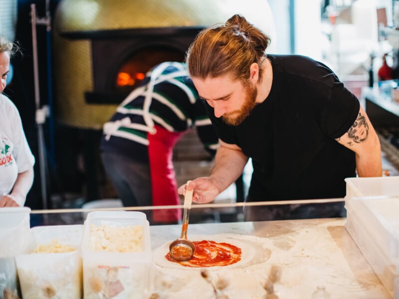 Man making pizza at a pizza making workshop