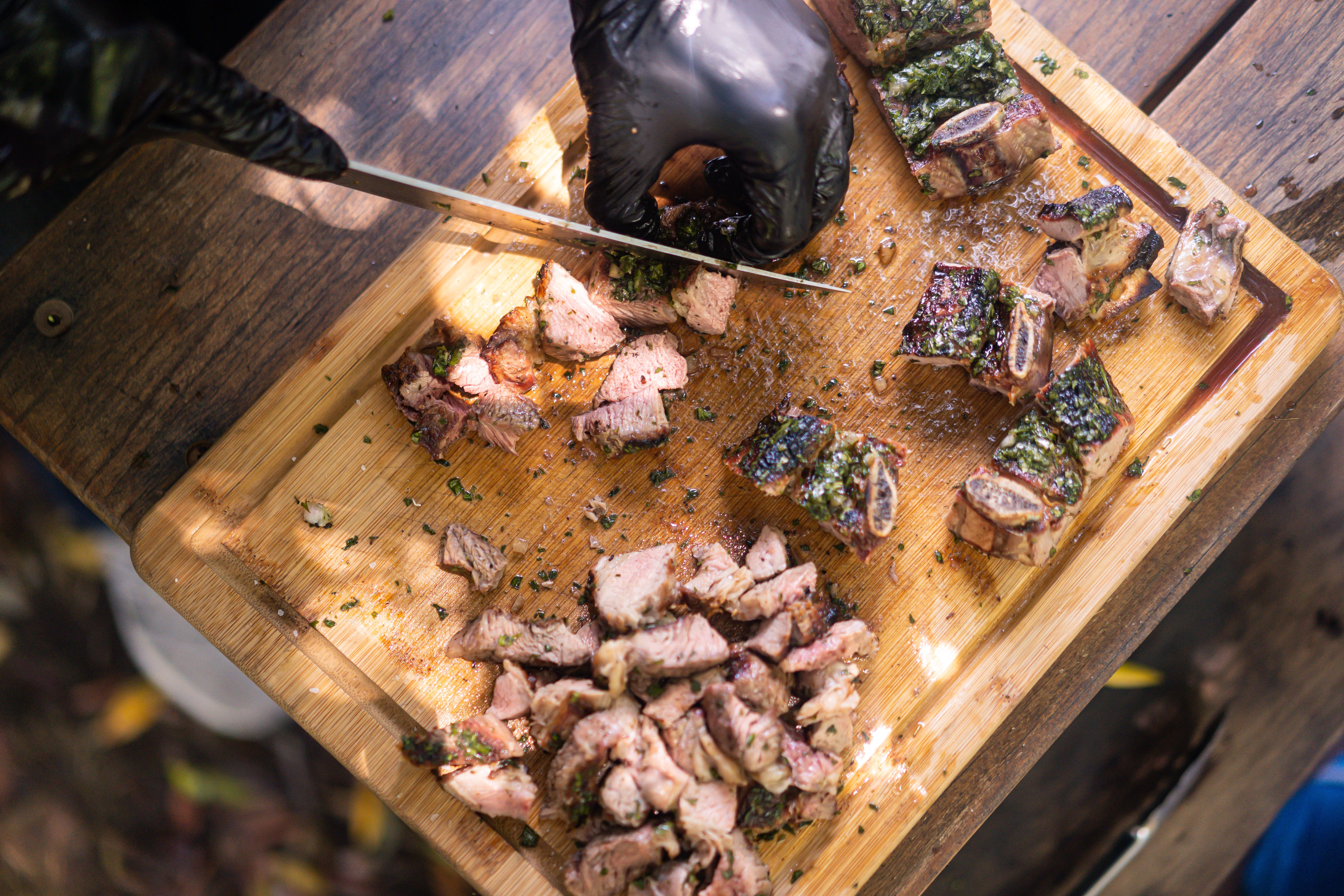 Close-up of person cutting BBQ meats