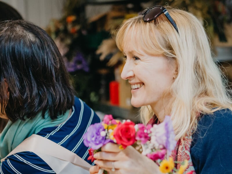 woman smiling at floristry workshop