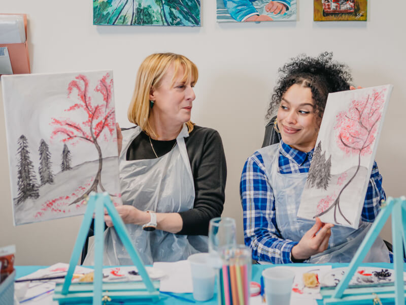 A mother and daughter at a paint and sip class