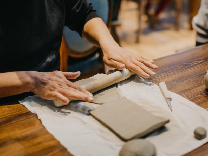 Man rolling out clay