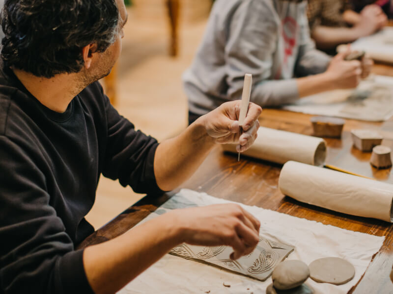 Father hand building clay