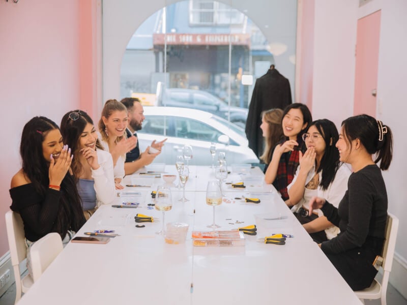 People laughing at a jewellery making class