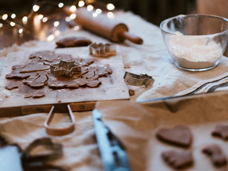 Table laid out with baking equipment and Christmas cookies