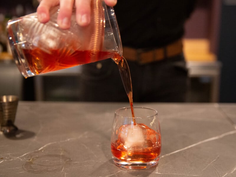 Close-up of a man pouring a cocktail