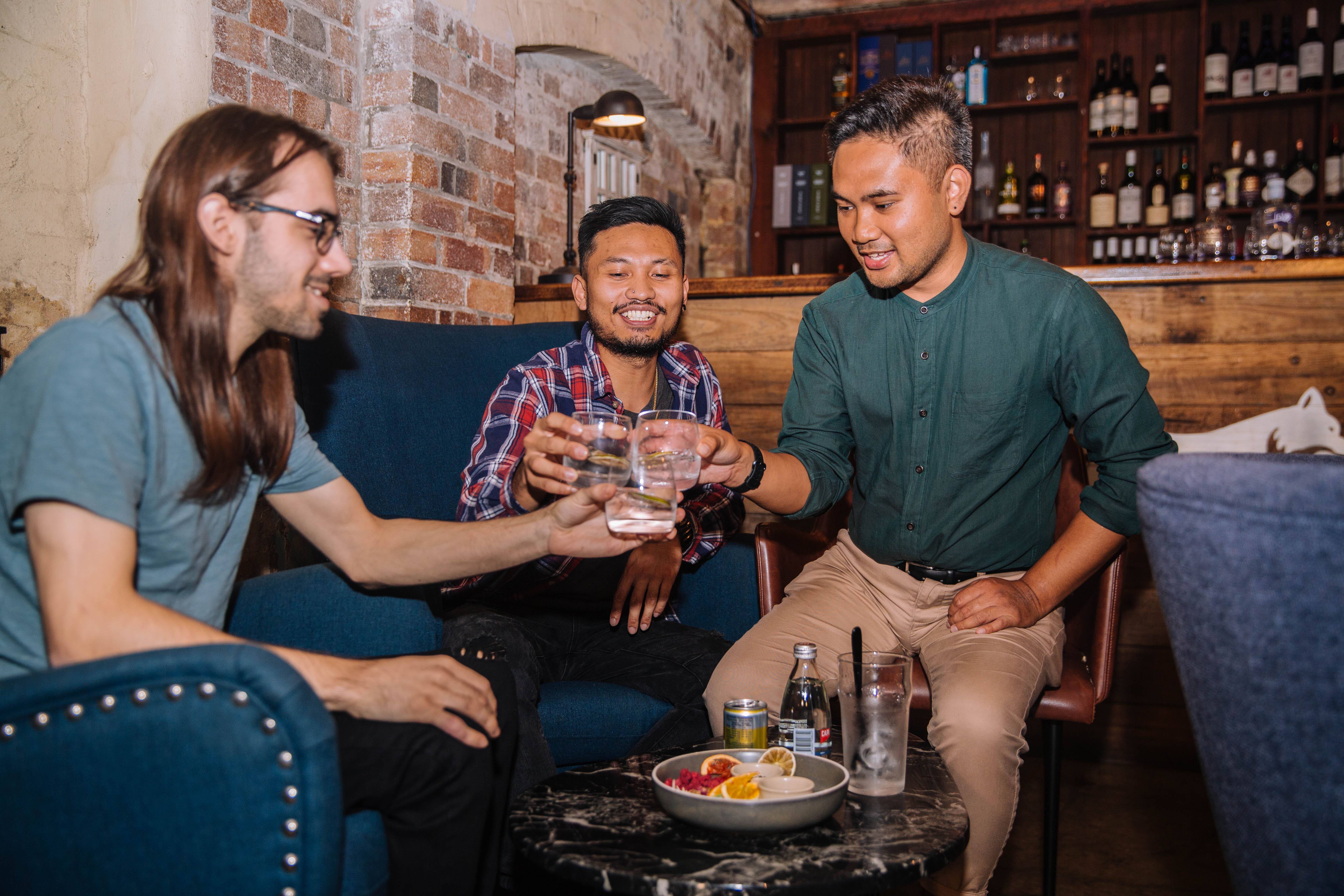 Group of men clinking glasses