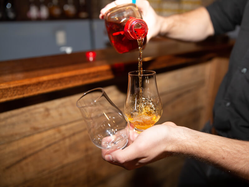 bartender pouring whisky 