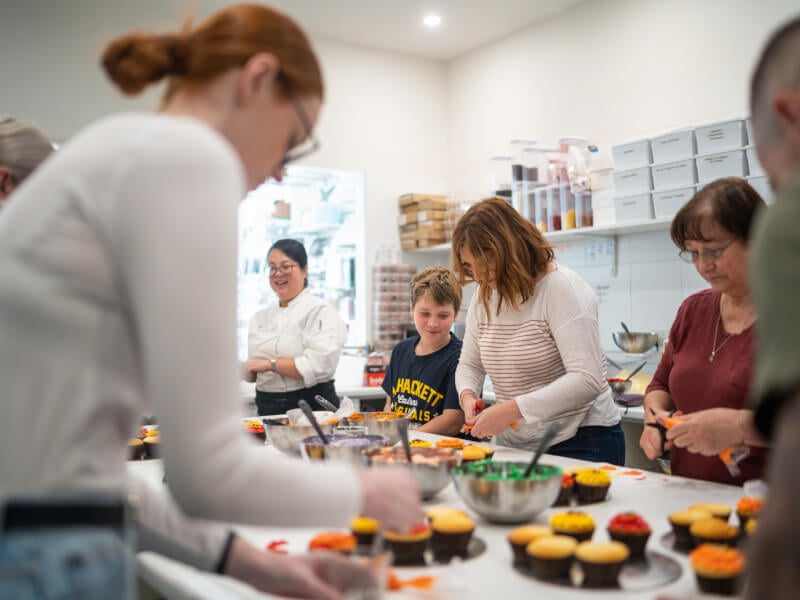 Mother and son decorating cupcakes