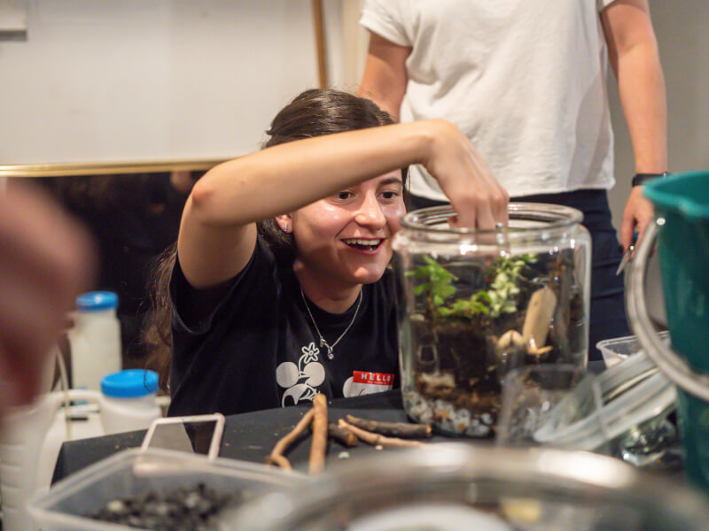 woman building DIY terrarium