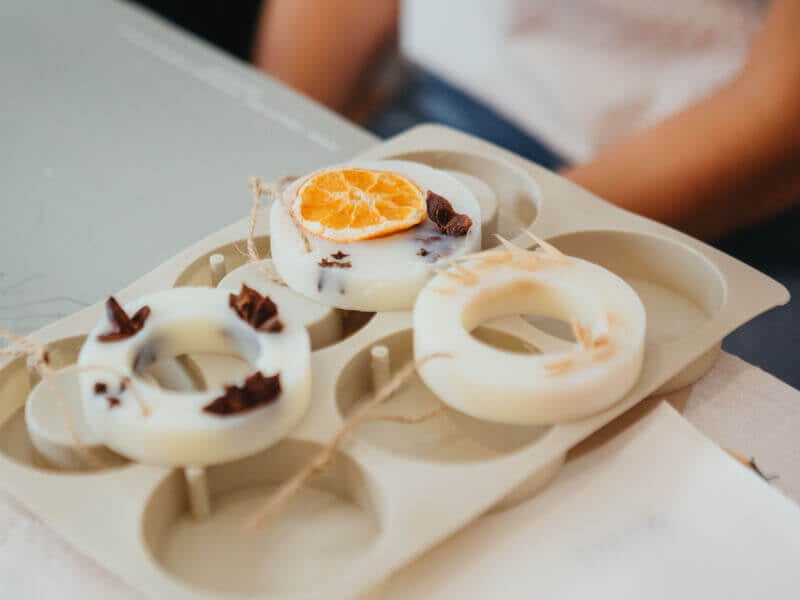 Three donut-shaped candles on top of a silicon mould
