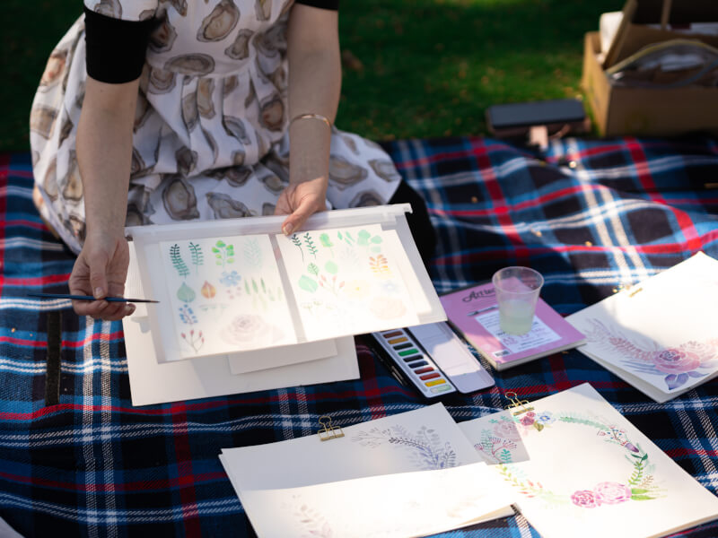 Close-up of watercolour artwork being shown