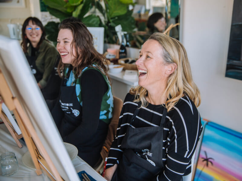 Women laughing at a painting class 