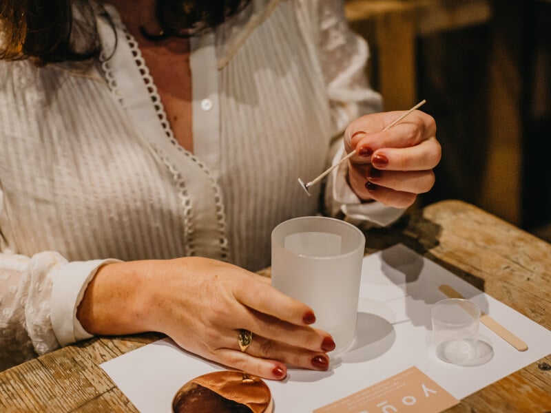A woman makes candles at workshop experience she was gifted