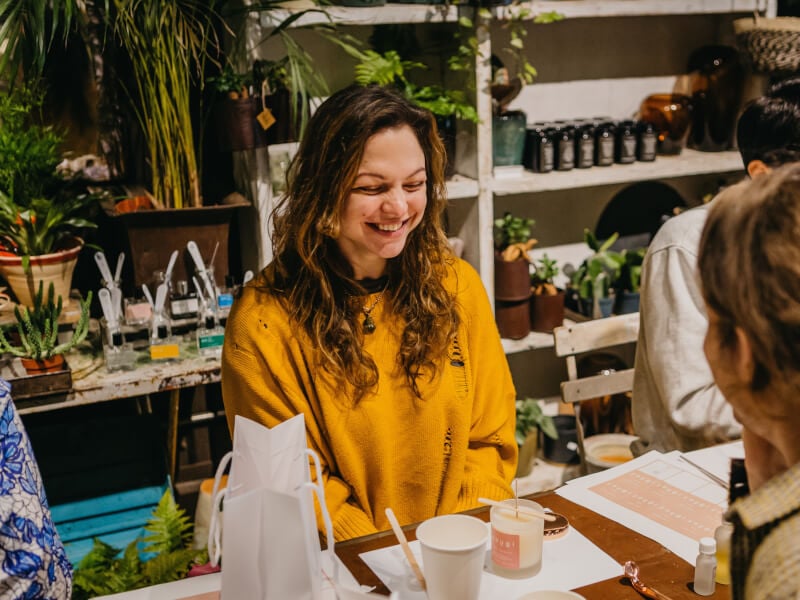 woman smiling at candle making class