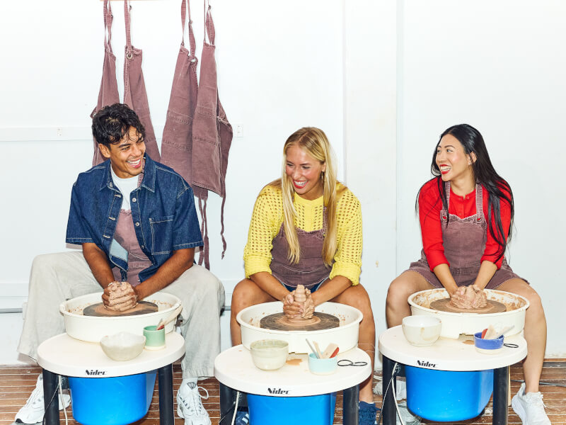 People enjoying a wheel throwing class