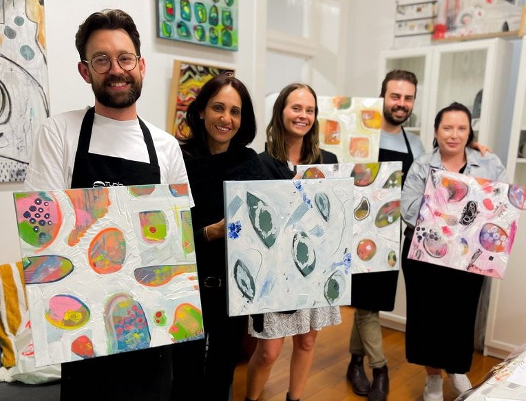 People showing off their abstract art pieces