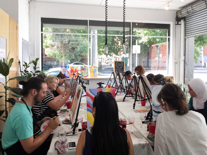 A group of painters at a paint and sip venue