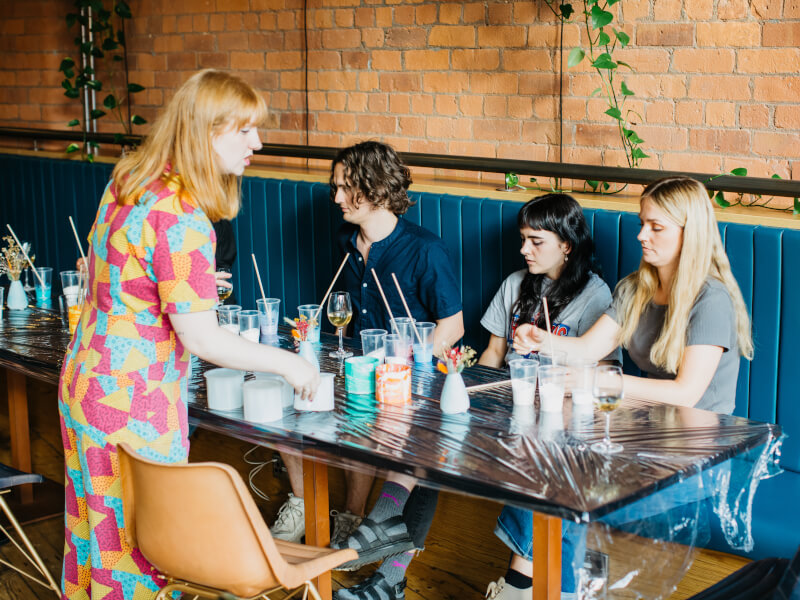 Group of friends at art table learning fluid art in Sydney