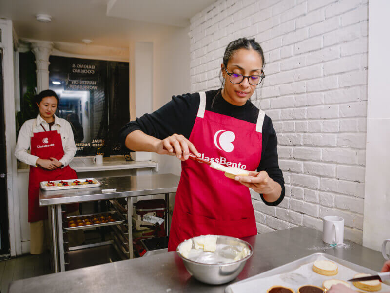 A woman enjoys making pastries at a baking class
