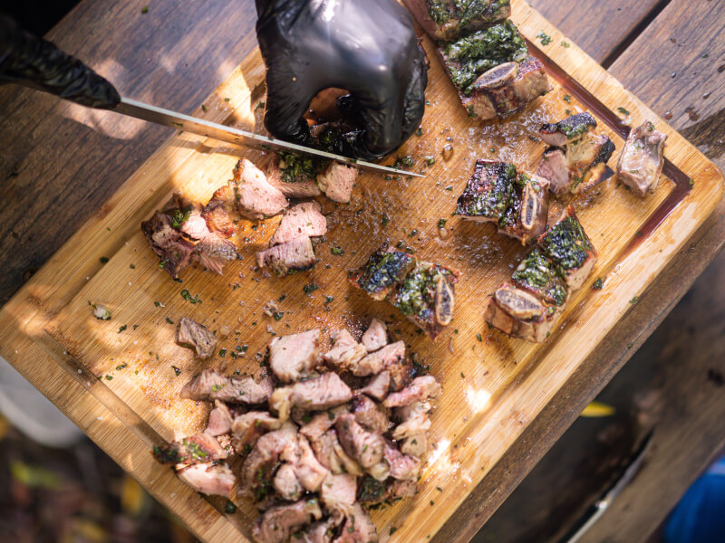 Person cutting BBQ meats