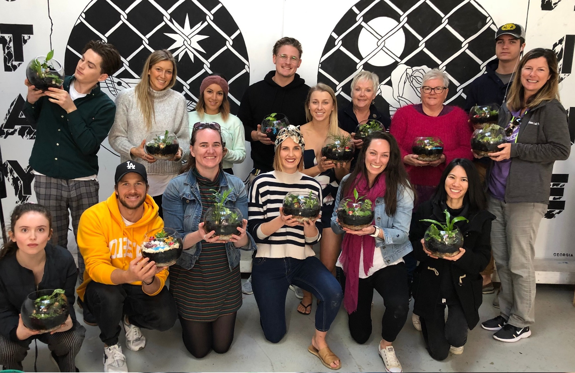 People holding DIY terrariums
