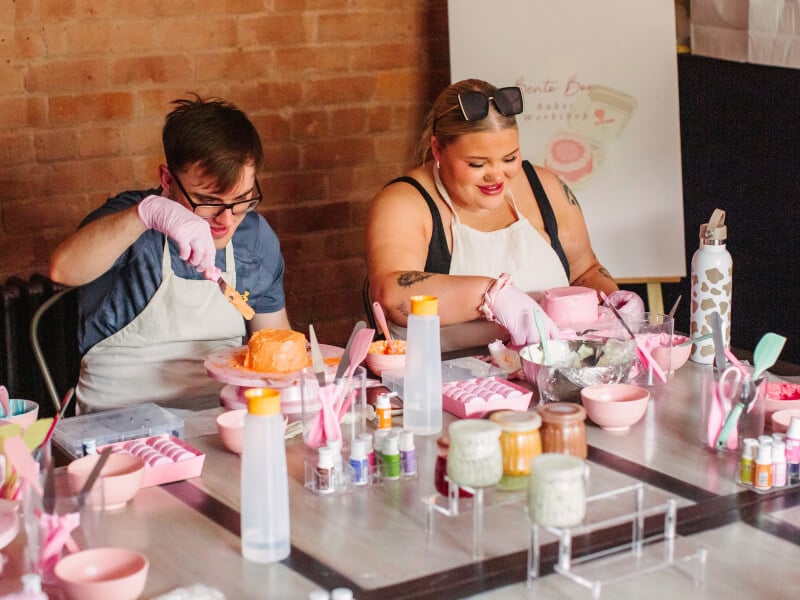 A couple decorate cakes