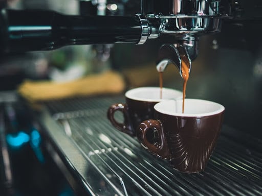 Coffee being poured through a portafilter