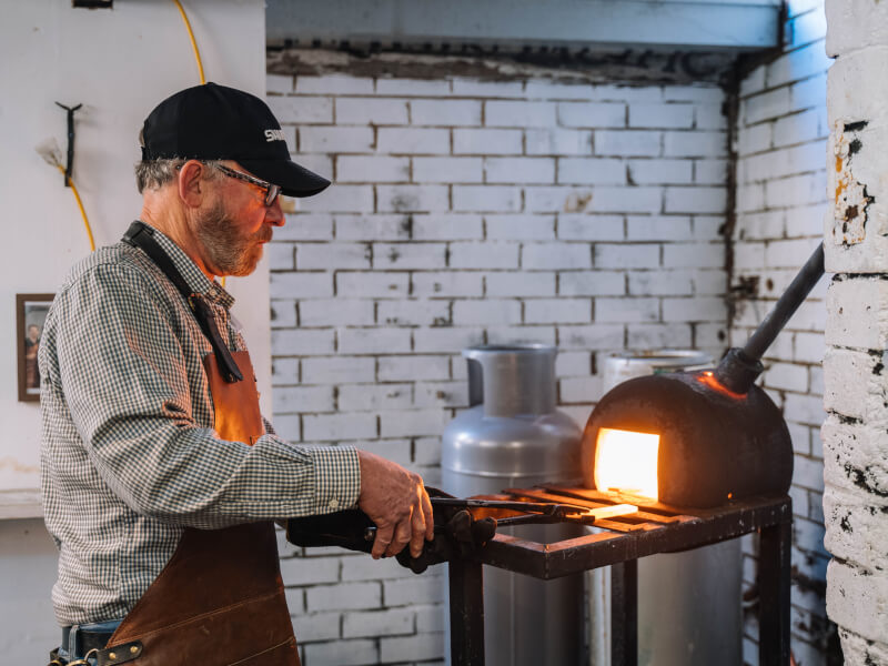 A man enjoys blacksmithing class he was gifted