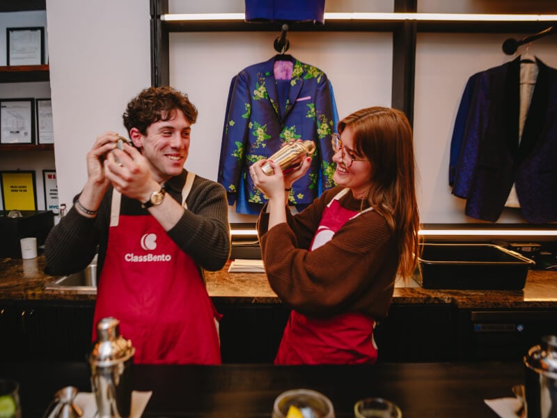 A man makes cocktails with a friend for his birthday