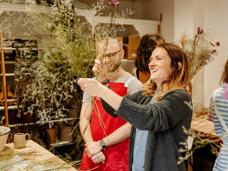 A couple and their flower arrangements at a workshop