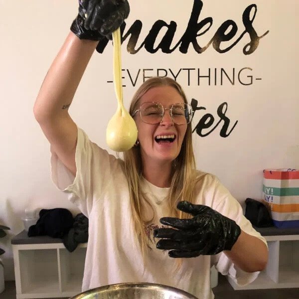 Woman holding up freshly-made burrata 
