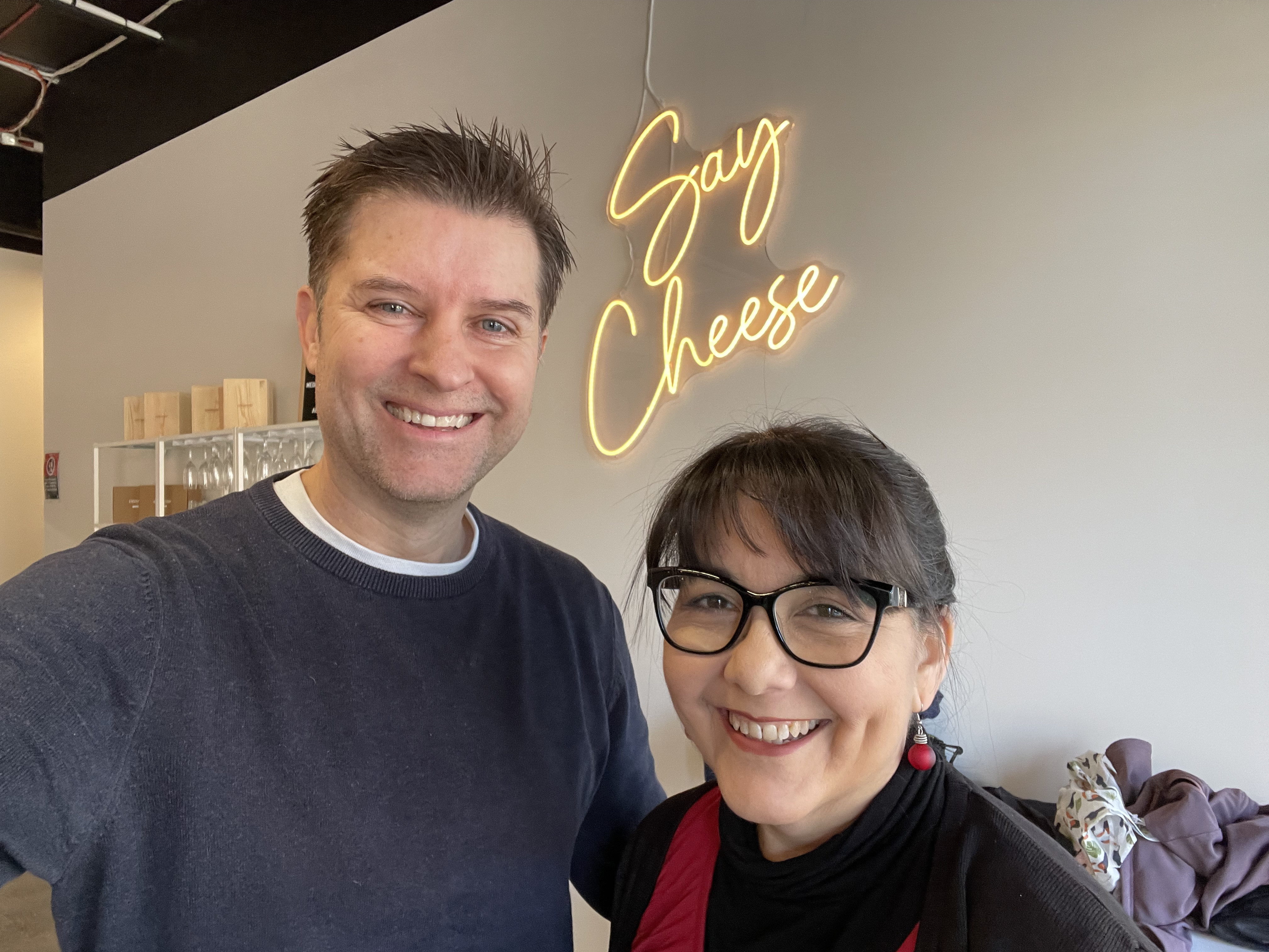 A husband and wife making cheese on date night