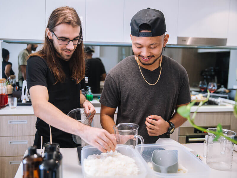 Two men making candles together