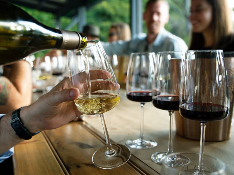 pouring wine into glasses