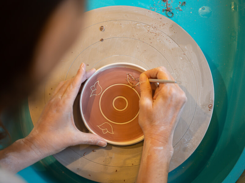 Hands painting ceramic