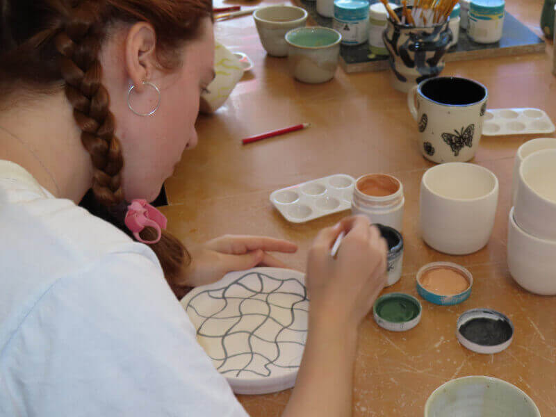 A woman painting ceramics