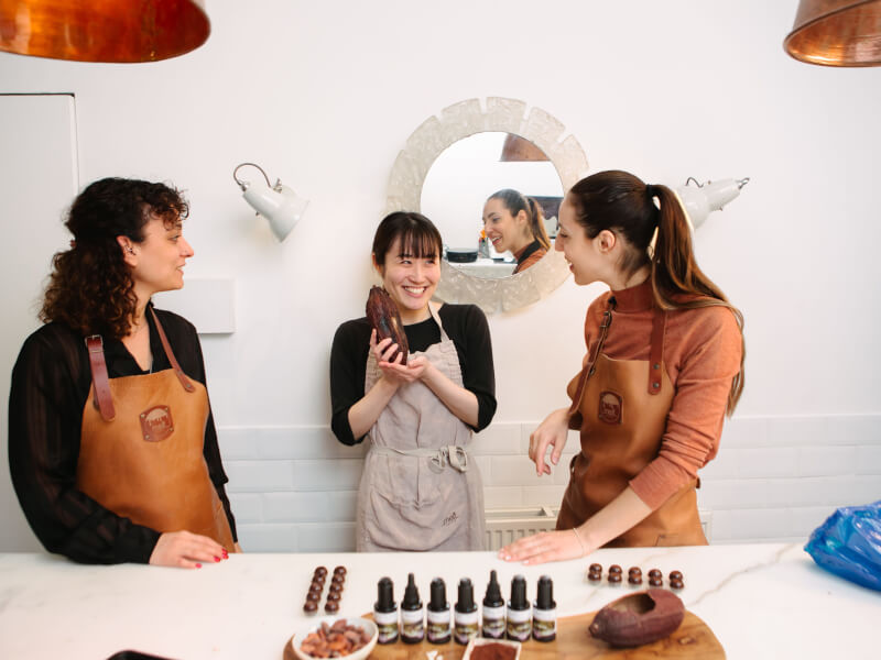 Three women celebrate a 40th birthday with chocolate making