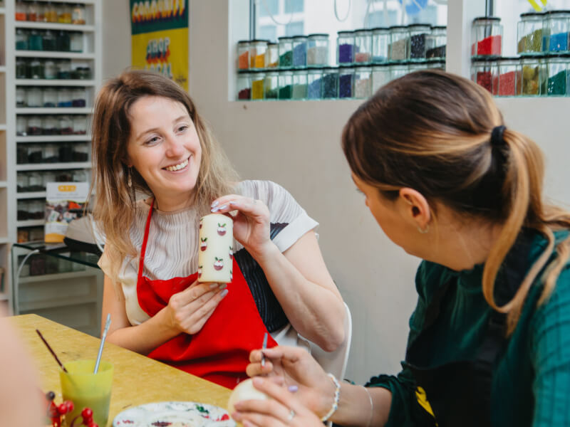 Two women make Christmas candles