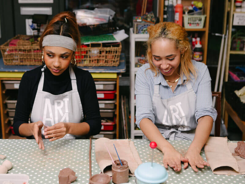 Two friends enjoy a pottery experience gift together