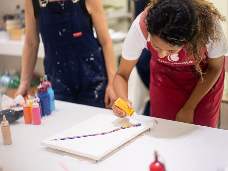 A woman focused on creating her abstract artwork