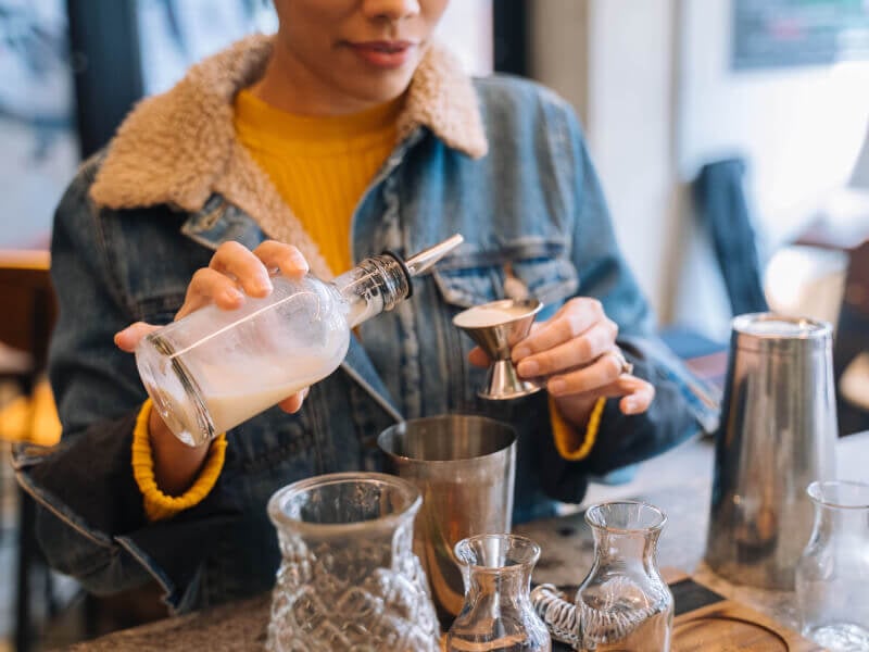 A woman making cocktails for her birthday