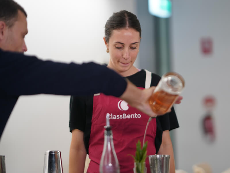 Woman having drink poured for her at brewery tour 