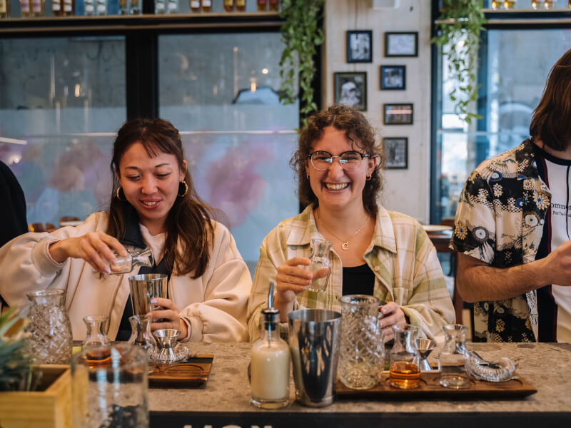 Two friends attend a cocktail class together for a lowkey birthday
